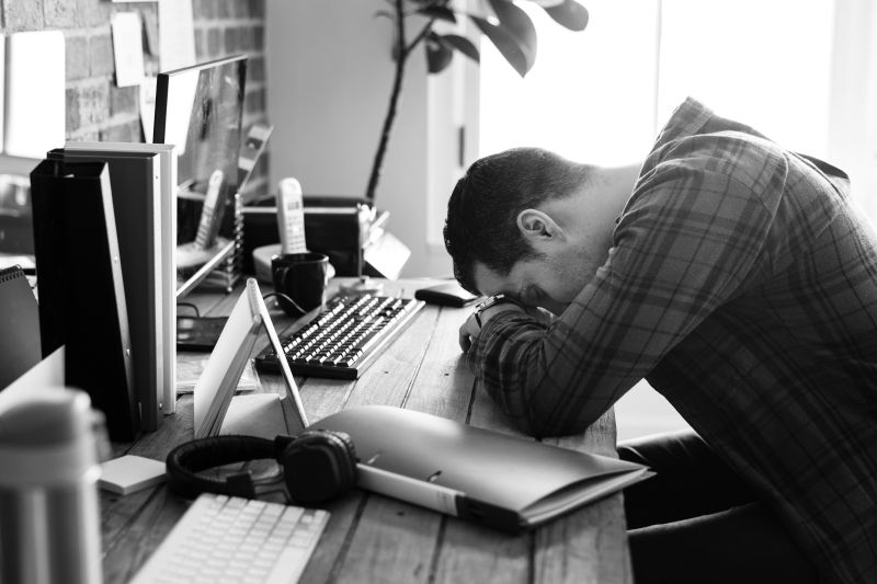 tired man napping on the working desk